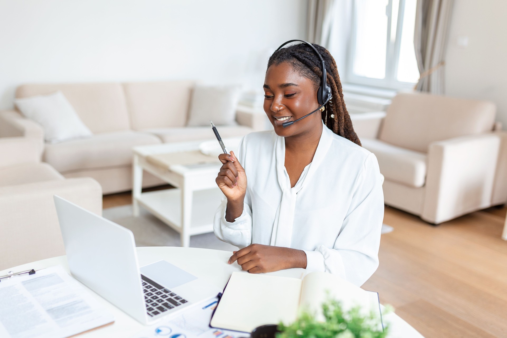 Shot of a businesswoman on a video call while sitting at her desk.Cropped shot of an attractive young woman using her laptop to make a video call at home
